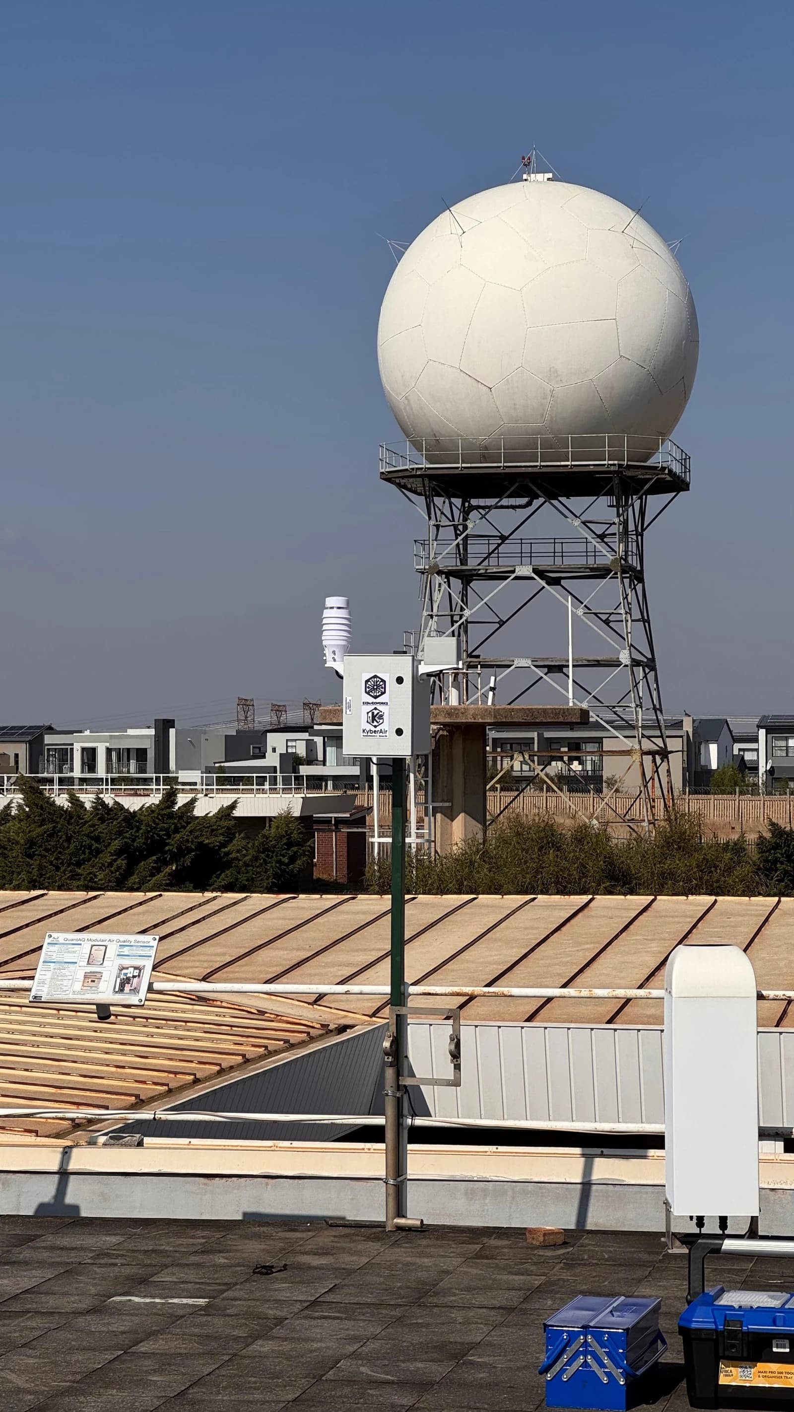 KyberAir on a rooftop pole with a large dome structure in the background