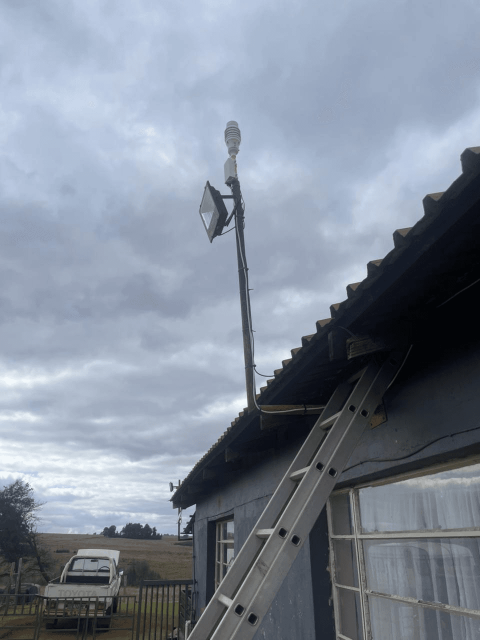 KyberMini outdoor monitoring unit installed on a roofline during field deployment.