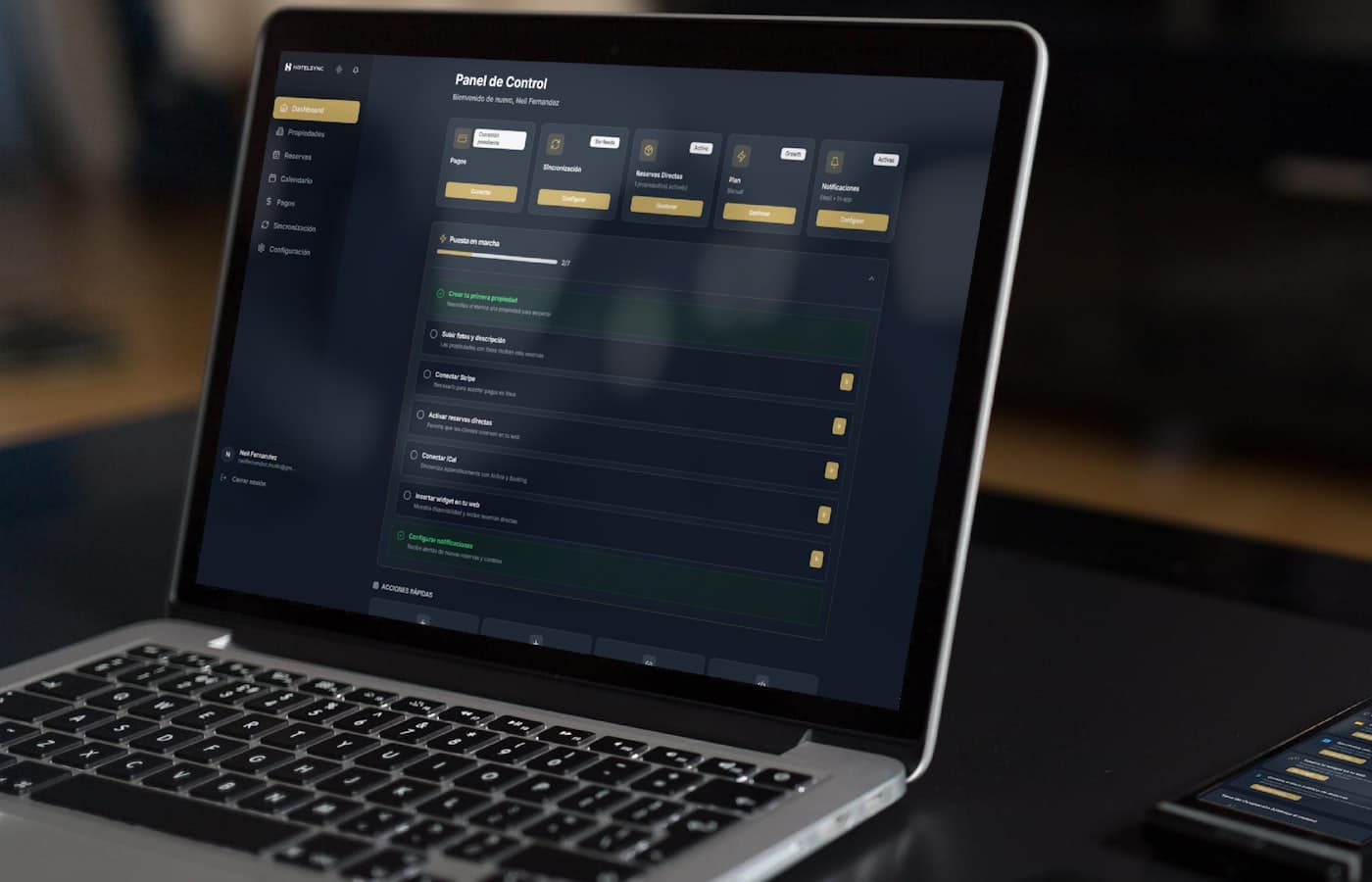 Mobile app development workspace with phone and laptop dashboards for South African operational software.