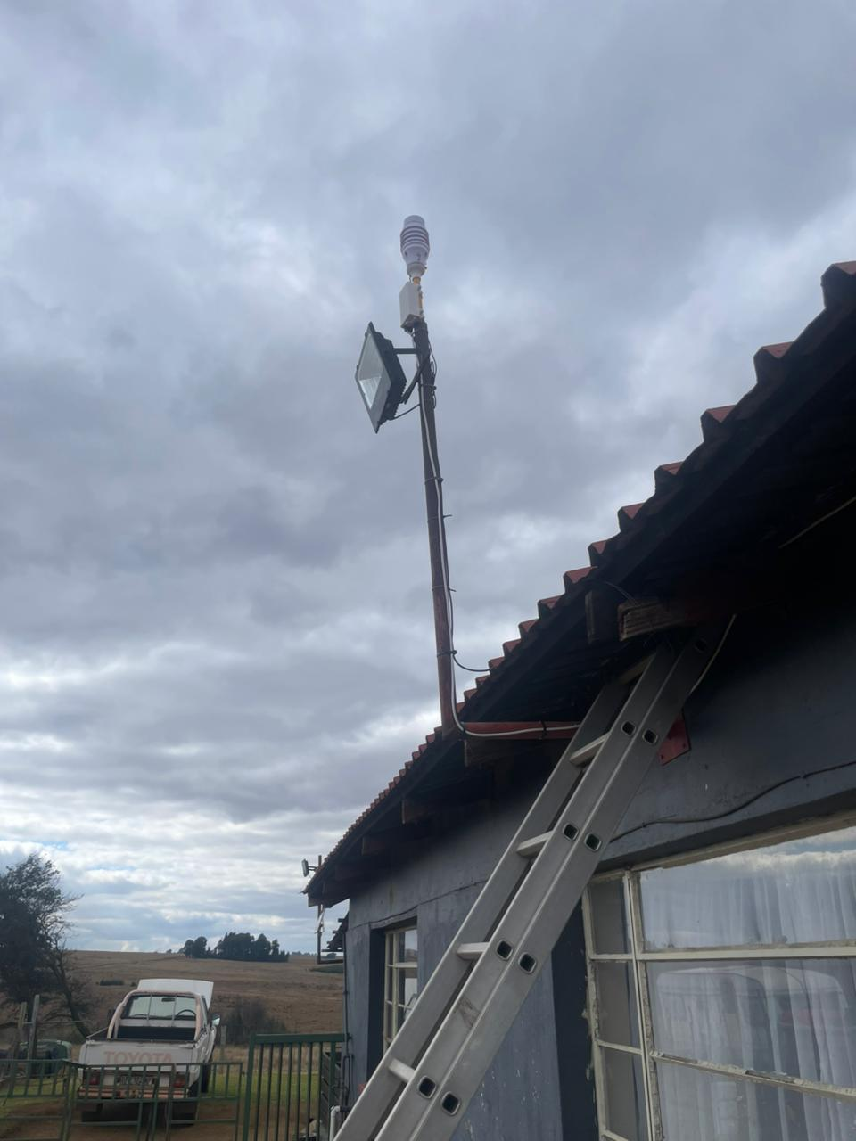 KyberMini outdoor monitoring unit installed on a roofline during field deployment.